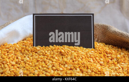 Raw split peas in a sack with a label Stock Photo