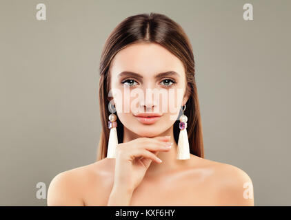 Perfect Young Woman Fashion Model with Jewelry Earrings on Background Stock Photo