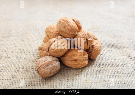 Walnuts in shell on a burlap Stock Photo