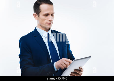 Serious nice businessman using a tablet Stock Photo
