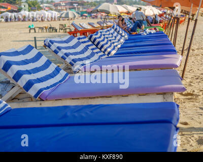 Goa, India - December, 21 2017 : Beach bed with umbrella at North Goa beach called Baga Beach Stock Photo