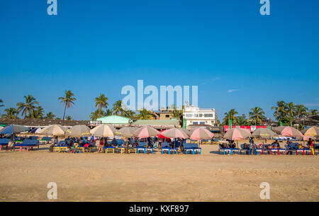 Goa, India - December, 21 2017 : Unidentified tourist relaxing using Beach beds and umbrellas to relax at North Goa beach called Baga Beach Stock Photo