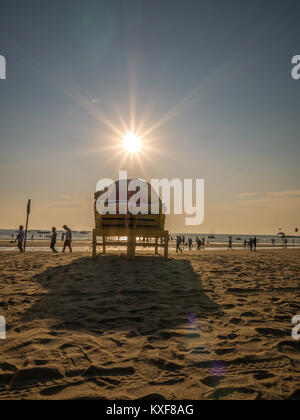 Goa, India - December, 21 2017 : Beach bed with umbrella with sun flares at North Goa beach called Baga Beach Stock Photo