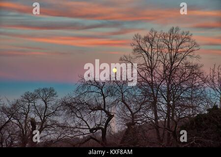 A very colorful sunset at Pelion mountain with view of the first day of 2018 full moon Stock Photo