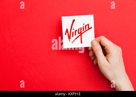 LONDON, UK - May 7th 2017: Hand holding Virgin logo. Virgin is a global corporation founded by Sir Richard Branson Stock Photo