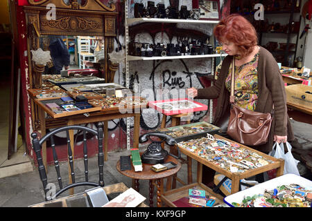 Woman at flea market looking at bric-a-brac in antiques stall, Athens, Greece Stock Photo