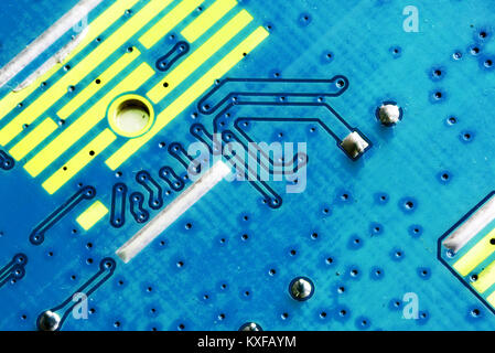 Electronic PCB printed circuit board in macro close-up with transistors circuitry and electric hardware elements including computer chip with copy spa Stock Photo