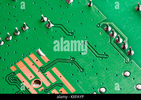 Electronic PCB printed circuit board in macro close-up with transistors circuitry and electric hardware elements including computer chip with copy spa Stock Photo