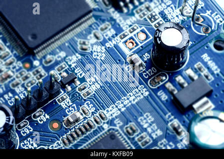 Electronic PCB printed circuit board in macro close-up with transistors circuitry and electric hardware elements including computer chip with copy spa Stock Photo