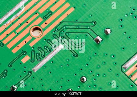 Electronic PCB printed circuit board in macro close-up with transistors circuitry and electric hardware elements including computer chip with copy spa Stock Photo