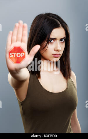 Domestic violence and abuse concept. Upset woman showing hand stop sign Stock Photo