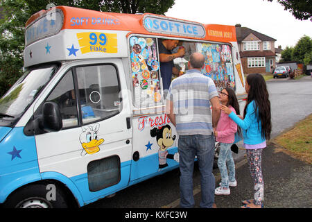 England, Kent, Orpington – Circa July 2014: Father buying his kids ices creams from a mobile ice cream seller. Stock Photo