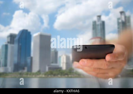 Hand of a businessman holding a smartphone. There is a network of business contacts. A concept of communication, this image focuses on blurring to be  Stock Photo