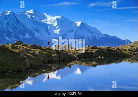 Athlete trail running at Lac De Chéserys, with the Mont Blanc in the background. Stock Photo