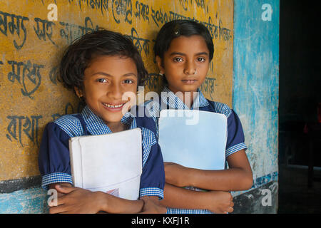 Portrait of two smiling schoolgirls with books in school library Stock ...