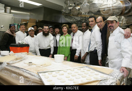 Washington, District of Columbia, USA. 6th Dec, 2005. First lady Laura Bush participates in a group photo with Rabbi Binyomin Taub, Rabbi Hillel Baron, and Rabbi Mendy Minkowitz who are overseeing the Kosherizing of the White House Kitchen in Washington, DC on December 6, 2005.Mandatory Credit: Shealah Craighead/White House via CNP Credit: Shealah Craighead/CNP/ZUMA Wire/Alamy Live News Stock Photo