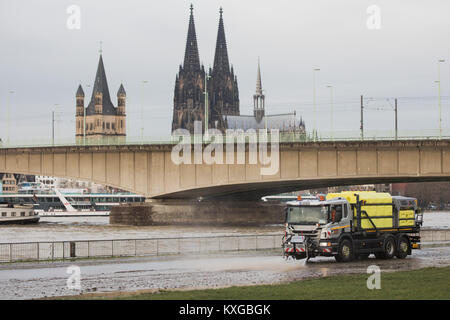 Cologne, Germany. 10th Jan, 2018. A cleaning vehicle in motion along the shore of the river Rhine in Cologne, Germany, 10 January 2018. The Rhine has been cleared for navigation once again after the rise in its waters' level. Credit: Rolf Vennenbernd/dpa/Alamy Live News Stock Photo