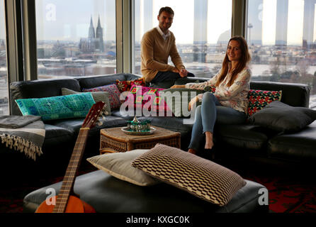 Models sitting on a 1950s boho-style sitting area in Cologne, Germany, 10 January 2018. The IMM International Furniture Fair takes place in Cologne between 15 and 21 January 2018. Photo: Oliver Berg/dpa Stock Photo