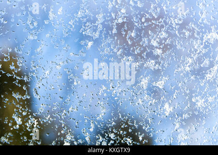 Winter ice pattern on the frozen window. New Year theme. Winter. Cold. Stock Photo
