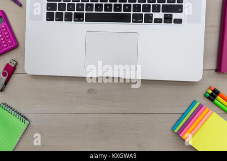 Laptop computer and stationery overhead on office desk Stock Photo