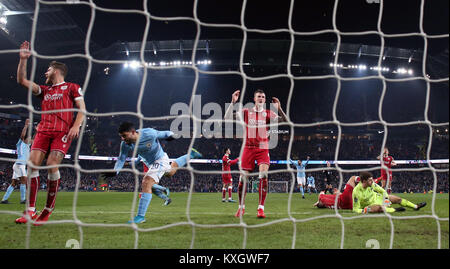 Bristol City players react after Manchester City's Sergio Aguero (second left) scores his side's second goal of the game during the Carabao Cup Semi Final, First Leg match at the Etihad Stadium, Manchester. Stock Photo