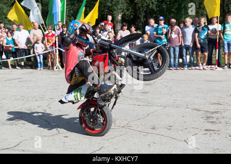 Verkhovazhye, Vologda region, Russia - August 10, 2013: Thomas Kalinin rides a wheelie. Thomas Kalinin driving a motorcycle with 3 years old, he is no Stock Photo