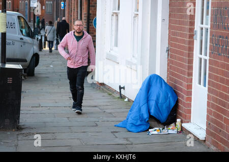 Homeless person in sleeping bag in freezing temperatures, The Calls, Leeds City Centre, Yorkshire. UK housing crisis deepens winter 2018 Stock Photo