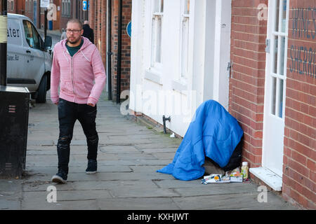 Homeless person in sleeping bag in freezing temperatures, The Calls, Leeds City Centre, Yorkshire. UK housing crisis deepens winter 2018 Stock Photo