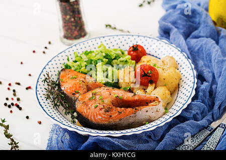 Dietary menu. Baked salmon steak with cauliflower, tomatoes and herbs. Proper nutrition. Healthy lifestyle Stock Photo