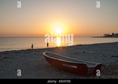 Sunset from the beach of Denia in Alicante (Spain) with boat in the foreground Stock Photo