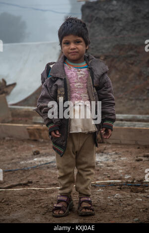 A portrait of a small kid looking in camera in north India. Stock Photo