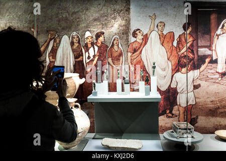 Jaen, Spain - December 29th, 2017: Woman using a museum mobile app. Jaen Iberian Museum Stock Photo