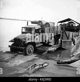 Australian Army Service Corps Trucks being unload by landing craft in World War II (New Guinea) Stock Photo