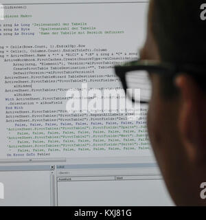 Close-up of person reading programming code on computer screen Stock Photo
