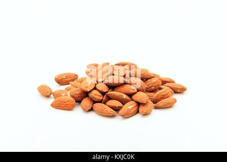 A heap of peeled almonds on white backgroundseeds Stock Photo