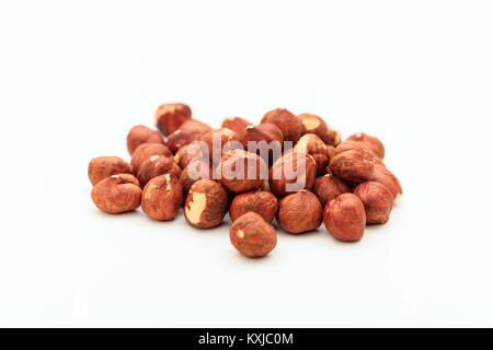 Heap of peeled hazelnuts on white background Stock Photo