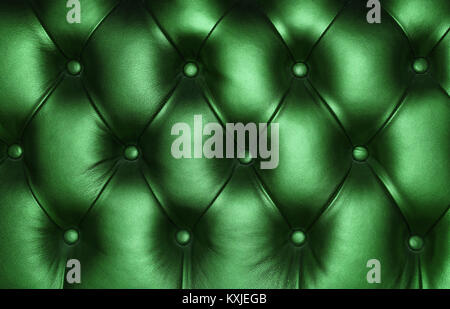 Dark emerald green capitone genuine leather background, retro Chesterfield style soft tufted furniture upholstery with deep diamond pattern and button Stock Photo