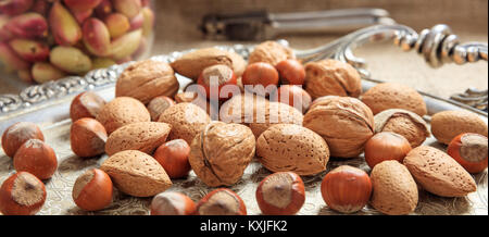 Almonds, walnuts and hazelnuts on a silver tray Stock Photo