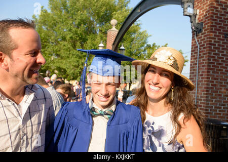 Teenage boy and family at graduation ceremony Stock Photo