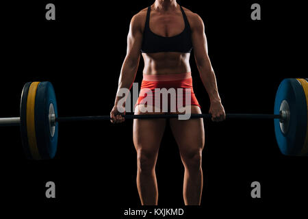 Mid section of young female weightlifter practicing barbell clean and jerk Stock Photo