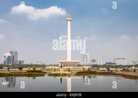 JAKARTA, INDONESIA - OCTOBER 21, 2014: The National Monument is a 132m tower in the centre of Merdeka Square, Jakarta, symbolizing the fight  for Indo Stock Photo