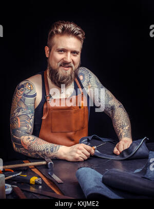Craftsman at work on his new leather product Stock Photo