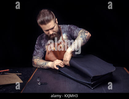 Currier of leather creating a new leather product in studio Stock Photo