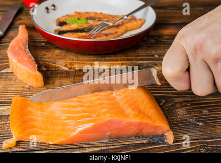 Fried salmon fillets on the pan on the wood Stock Photo