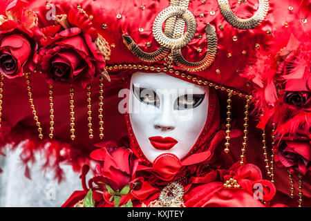 Venice, Italy- February 18th, 2012: Portrait of person in a red venetian disguise during the Venice Carnival days. Stock Photo