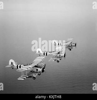 Three rocket-armed Swordfish on a training flight, August 1944. The aircraft are painted with Invasion stripes The Fairey Swordfish was a biplane torpedo bomber designed by the Fairey Aviation Company. Stock Photo