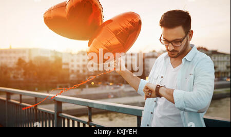 Sad man waiting for date on valentine date Stock Photo