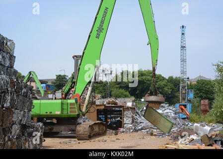 electomagnetic on crane sorting through scrap metal at scrapyard leeds yorkshire united kingdom Stock Photo