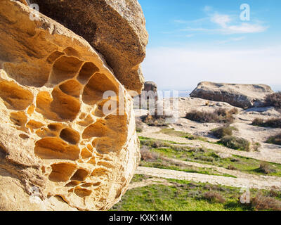 Perforated chalk-stone rock in the Gobustan National Park, Azerbaijan Stock Photo