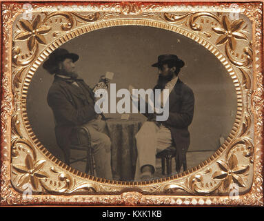Seated Gamblers Playing Cards With Four Clubs In The Left Gambler's Hand Stock Photo